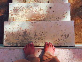 Low section of boy standing on steps