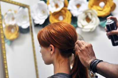 Side view of young doing hair styling