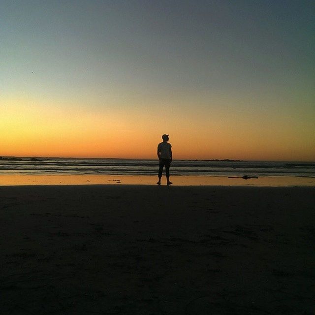 beach, sea, sunset, silhouette, shore, horizon over water, sand, water, clear sky, tranquility, full length, tranquil scene, copy space, scenics, standing, walking, leisure activity, beauty in nature