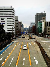 Cars on road amidst buildings in city