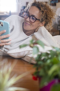 Portrait of young woman using mobile phone