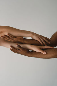 Crossed arms of different skin colors