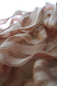 Close-up shot of light pink ruffles/frills on a textile.