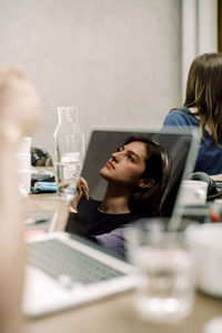 Reflection of businesswoman seen on laptop