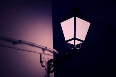 Low angle view of illuminated lamp against sky