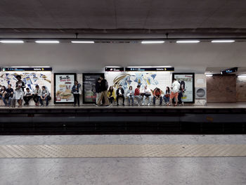 People walking on railroad station platform