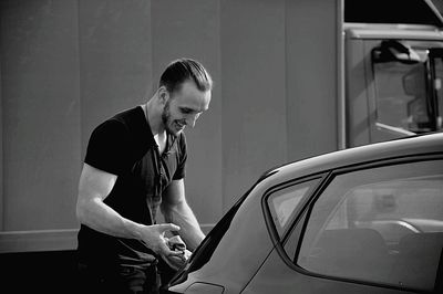 Smiling man washing car