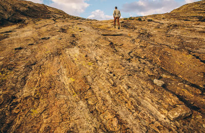 Full length of man climbing on rock