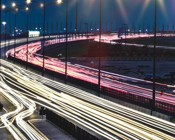 High angle view of light trails on bridge at night