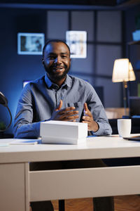Portrait of young man sitting in office