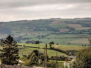 High angle view of field against cloudy sky