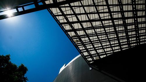 Low angle view of modern building against clear blue sky