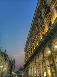 Low angle view of illuminated building against sky