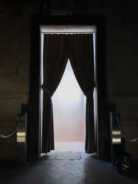 Empty entrance into corridor of building with curtain 
