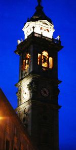 Low angle view of clock tower against blue sky