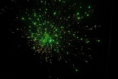 Low angle view of firework display at night