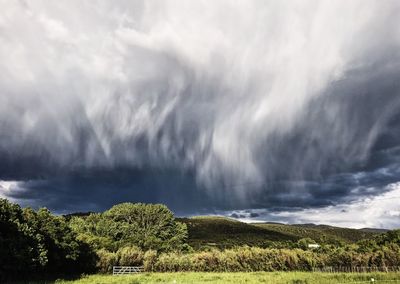 Scenic view of storm clouds over landscape