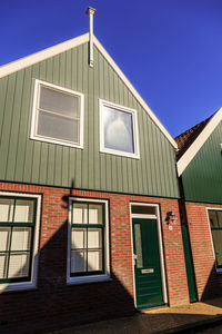 Low angle view of building against clear blue sky