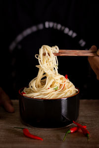 Instant noodles in a ready-to-eat cup with a black background.