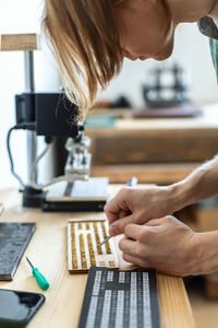 Midsection of woman working at table