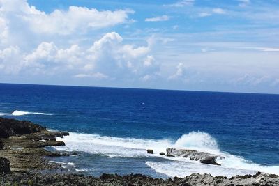 Scenic view of sea against cloudy sky