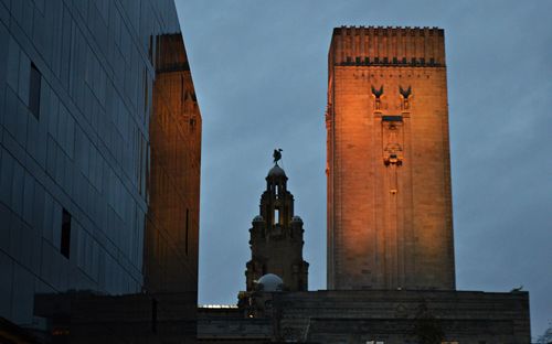 Low angle view of statue in city against sky