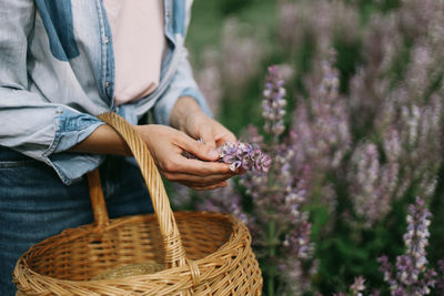 Midsection of woman holding wicker basket