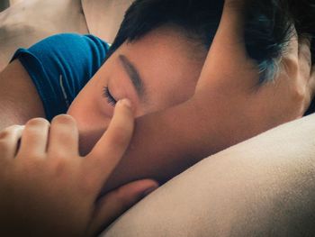 Close-up of baby lying on bed
