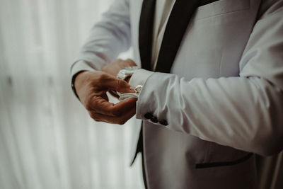 Midsection of man holding umbrella