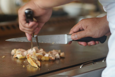 Midsection of man preparing food in kitchen