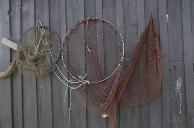 Close-up of fishing nets on rustic fence
