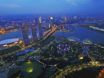 Aerial view of illuminated buildings in city at night