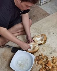 High angle view of man preparing food on table