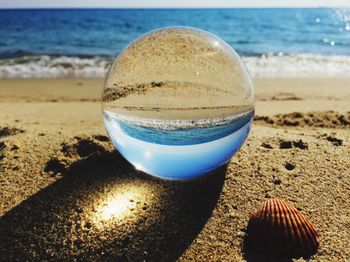 Close-up of water on beach against sky
