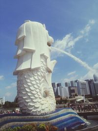 Low angle view of statue against sky in city