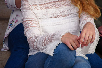 Midsection of woman sitting at home