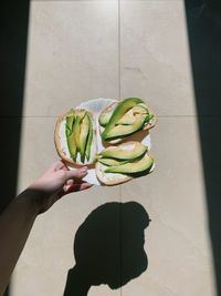 Cropped hand of woman holding fruit