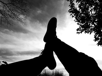 Low angle view of silhouette person against sky during sunset