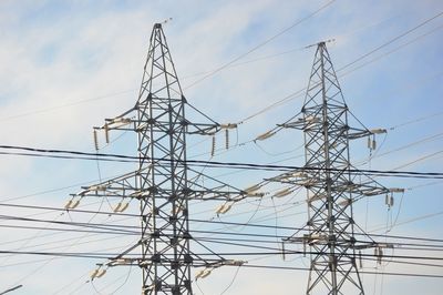 Low angle view of electricity pylon against sky