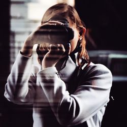 Close-up of woman photographing with camera