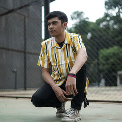 Portrait of young man sitting outdoors