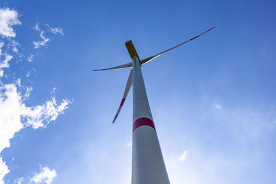 Low angle view of windmill against sky