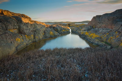 Scenic view of land against sky during sunset