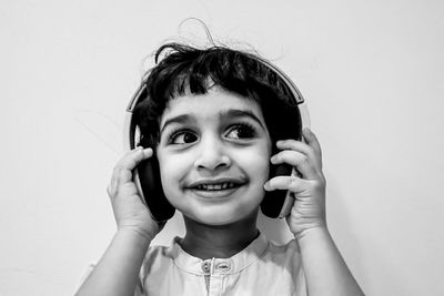 Portrait of happy boy holding headphones 