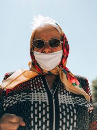 Portrait of woman wearing sunglasses against sky