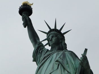 Low angle view of statue against sky