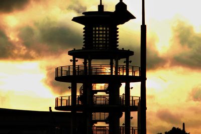 Silhouette of building against cloudy sky