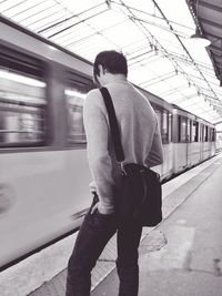 Full length of man holding train at subway station