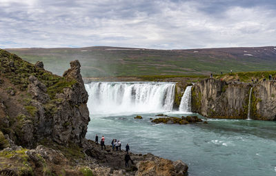 Scenic view of waterfall against sky