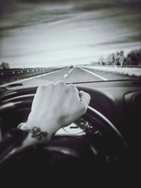 Close-up of woman hand in car